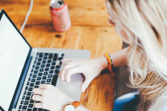 A woman on a laptop is finding affordable housing in Fort Lee NJ.